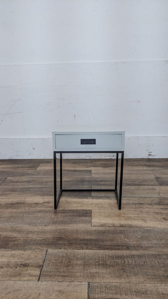 Reperch brand end table with a single drawer and black metal frame against a white wall.