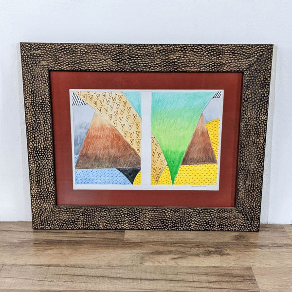 1. Framed abstract print by Sudie Rakusin with geometric shapes, matted in red and displayed in a textured frame.