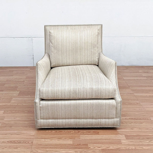 Jessica Charles Furniture lounge chair with nair head trim, beige striped upholstery, on wooden floor.