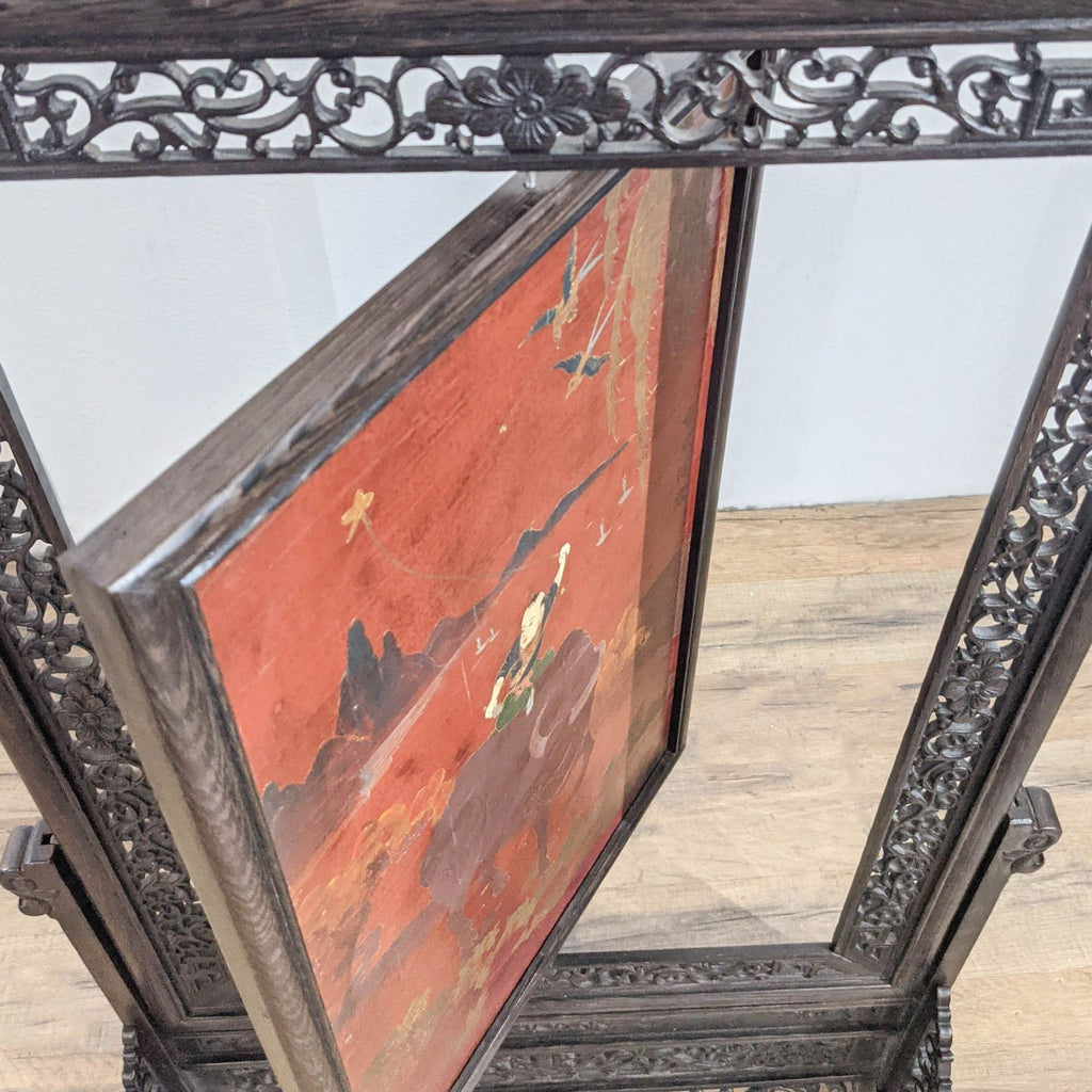 3. Close-up angled view of Reperch carved frame, highlighting the rotating panel and vibrant traditional painting.