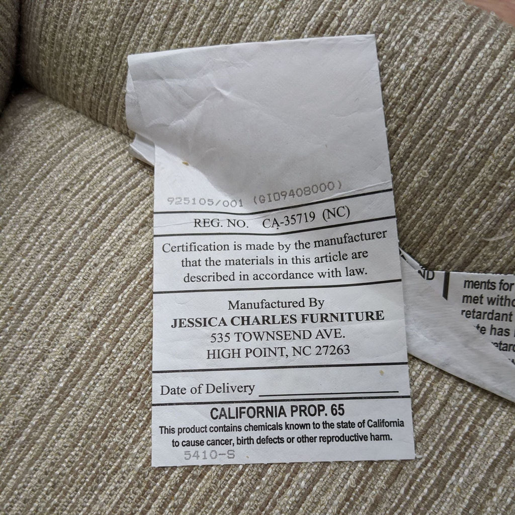 Alt text: Jessica Charles Furniture label on fabric containing information about manufacturer and California Prop 65 warning.
