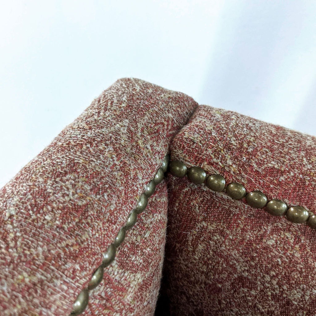 Close-up of Reperch lounge chair fabric with decorative seam and beading.
