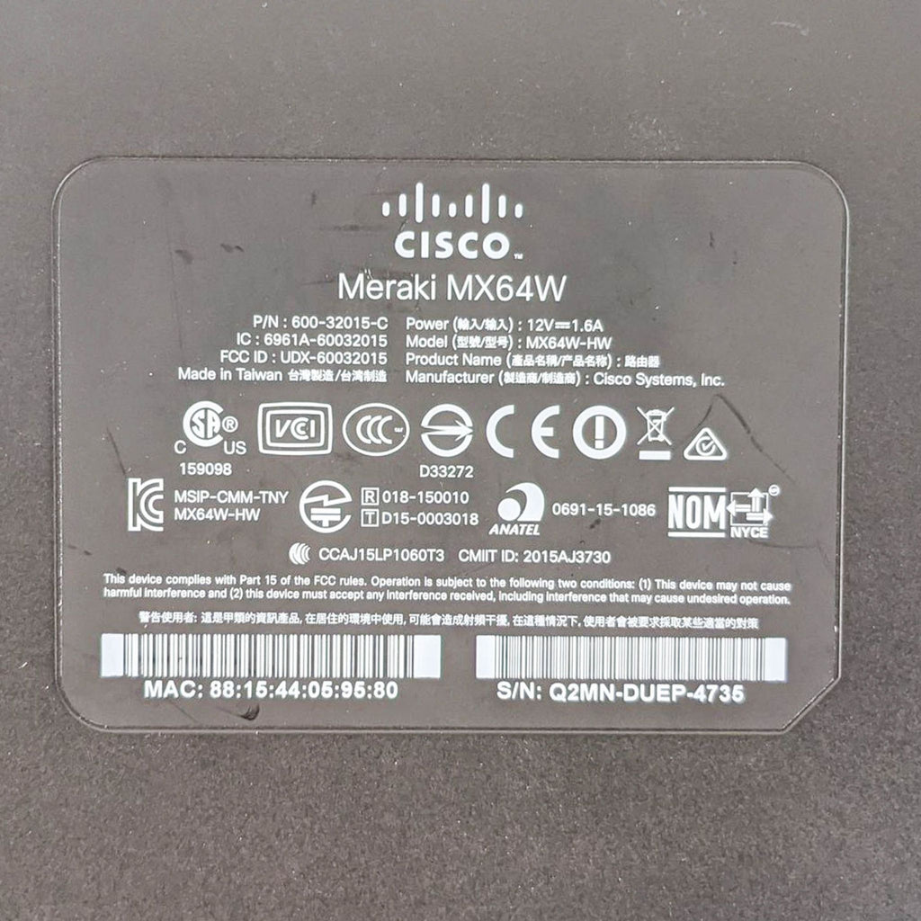 2. Detailed label on the bottom of a Cisco Meraki MX64W with model and regulatory information.