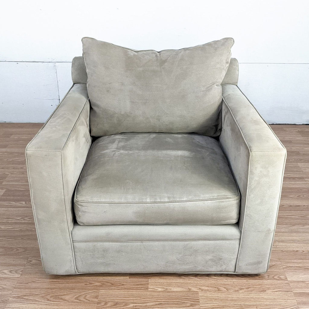 Reperch brand lounge chair in beige with plush cushioning and a single pillow, showcased on a wooden floor.