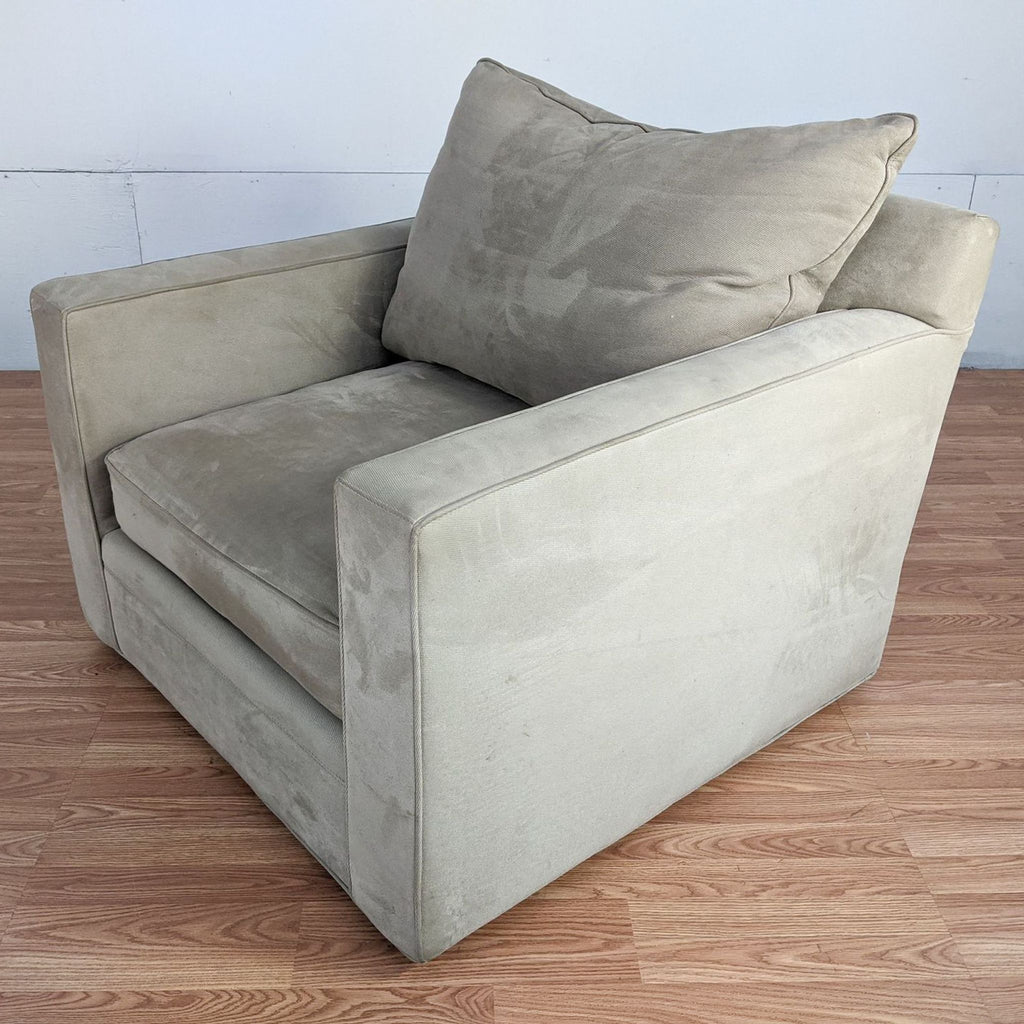Beige Reperch lounge armchair with plush cushions on wooden floor.