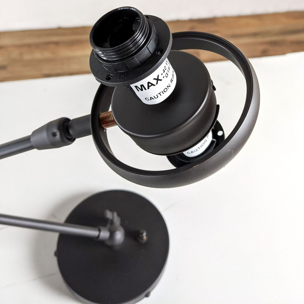 Alt text 2: Close-up of Rejuvenation's black conifer articulating lamp head with label and adjustable neck against a white backdrop.