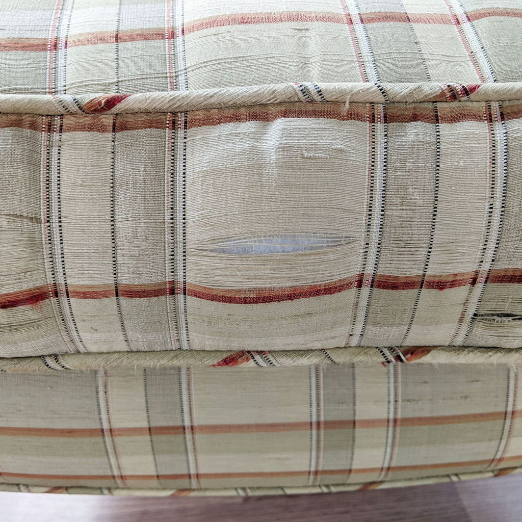 Close-up of a Drexel lounge item showing frayed fabric with visible wear and patterned upholstery.